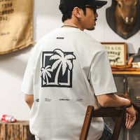 Pull ample avec graphique de palmier rétro 