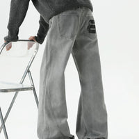 Pantaloni in denim a gamba larga patchwork strappati 